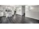 Open kitchen featuring white cabinets, stainless steel appliances, an island, and hardwood floors at 8022 W 78Th Way, Arvada, CO 80005