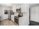Updated kitchen featuring white cabinets, stainless steel appliances, and access to the back door at 8022 W 78Th Way, Arvada, CO 80005