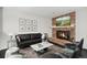Cozy living room featuring a brick fireplace, hardwood floors, comfortable seating, and stylish decor at 8022 W 78Th Way, Arvada, CO 80005