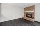 Inviting living room showcasing a brick fireplace, hardwood floors, and comfortable seating at 8022 W 78Th Way, Arvada, CO 80005