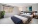 Spacious main bedroom with a large window and a comfortable king-size bed at 8022 W 78Th Way, Arvada, CO 80005