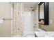 Bathroom featuring a shower with a decorative curtain and black medicine cabinet at 9963 E Carolina Cir # 104, Aurora, CO 80247