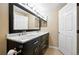 Bathroom featuring a double vanity, granite countertops, and a large mirror at 9963 E Carolina Cir # 104, Aurora, CO 80247