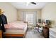 Comfortable bedroom featuring neutral tones, a ceiling fan, and natural light from a window at 9963 E Carolina Cir # 104, Aurora, CO 80247