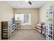 Carpeted bedroom with ceiling fan and window for natural light at 9963 E Carolina Cir # 104, Aurora, CO 80247
