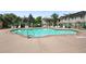 Relaxing community pool with plenty of seating, lush landscaping, and fenced perimeter for privacy and safety at 9963 E Carolina Cir # 104, Aurora, CO 80247