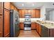 Spacious kitchen featuring stainless steel appliances, granite countertops, and wooden cabinets at 9963 E Carolina Cir # 104, Aurora, CO 80247