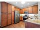 Kitchen with stainless steel appliances, granite countertops, and wood cabinets at 9963 E Carolina Cir # 104, Aurora, CO 80247