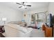 Bright living room with sliding glass doors to balcony and a ceiling fan at 9963 E Carolina Cir # 104, Aurora, CO 80247
