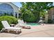 Community pool and lounge area with lounge chairs, jacuzzi, mature trees, and lush landscaping at 9963 E Carolina Cir # 104, Aurora, CO 80247