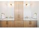 Elegant bathroom with dual sinks, quartz countertops, and stylish gold fixtures at 4238 Zuni St, Denver, CO 80211