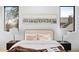 Close up of a beautifully styled bedroom with a comfortable bed, bedside tables, and artwork at 4238 Zuni St, Denver, CO 80211