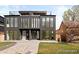 Modern two-story home with large windows, sleek lines, rooftop deck, and well-maintained landscaping at 4238 Zuni St, Denver, CO 80211