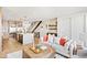 Bright and airy living room with a view into the kitchen and staircase at 4238 Zuni St, Denver, CO 80211