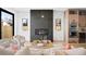Cozy living room with a modern fireplace, neutral decor, and a view to the backyard at 4238 Zuni St, Denver, CO 80211
