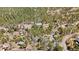 Expansive aerial view of a wooded community featuring various homes nestled among lush, mature trees at 11798 Ridge Rd, Golden, CO 80403