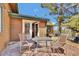 Comfortable back patio seating with glass table and chairs, offering a perfect space to unwind at 11798 Ridge Rd, Golden, CO 80403