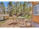Outdoor back patio features flagstone, outdoor seating, and a wooded area at 11798 Ridge Rd, Golden, CO 80403