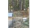 The natural wooded backyard setting is near a decorative bench, where a bobcat is seen in its natural habitat at 11798 Ridge Rd, Golden, CO 80403