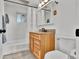Cozy bathroom featuring a wooden vanity, framed mirror and shower with white tile at 11798 Ridge Rd, Golden, CO 80403