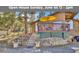 Charming cabin with a wooden deck, stone accents, and inviting steps leading to the front entrance at 11798 Ridge Rd, Golden, CO 80403