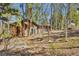 Exterior view of home surrounded by trees, featuring a walkout basement and natural landscaping at 11798 Ridge Rd, Golden, CO 80403