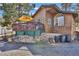 Exterior view of home with a deck, rock foundation, and large arched window at 11798 Ridge Rd, Golden, CO 80403