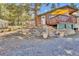 Exterior view of home with stone landscaping and gravel driveway at 11798 Ridge Rd, Golden, CO 80403