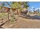 Exterior of home with a gated entrance, deck, and natural landscaping at 11798 Ridge Rd, Golden, CO 80403