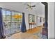 Bright living room with a wood stove, hardwood floors, sliding doors, and deck access at 11798 Ridge Rd, Golden, CO 80403