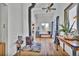 Bright living room featuring hardwood floors, wood burning stove, ceiling fan, and stylish decor at 11798 Ridge Rd, Golden, CO 80403