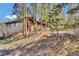 Exterior side view of the home showing wood siding and natural surroundings at 11798 Ridge Rd, Golden, CO 80403