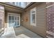 Private back patio featuring tile floor, stucco wall, and sliding glass door to bring the outdoors in at 6480 Silver Mesa Dr # B, Highlands Ranch, CO 80130