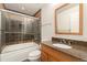 Bathroom showcasing a shower-tub combo, granite countertop vanity, and modern finishes for a luxurious experience at 6480 Silver Mesa Dr # B, Highlands Ranch, CO 80130