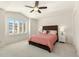 Sunlit bedroom featuring neutral walls, a ceiling fan, and a window with shutters for a bright and airy feel at 6480 Silver Mesa Dr # B, Highlands Ranch, CO 80130