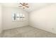 Bright bedroom featuring neutral carpet, a ceiling fan, and a window with shutters for ample natural light at 6480 Silver Mesa Dr # B, Highlands Ranch, CO 80130