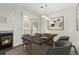 Elegant dining area features a modern chandelier, fireplace, and shutters for adjustable lighting at 6480 Silver Mesa Dr # B, Highlands Ranch, CO 80130