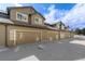 Attached garages in a townhome community featuring neutral paint scheme and concrete parking at 6480 Silver Mesa Dr # B, Highlands Ranch, CO 80130