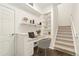 Inviting home office nook featuring custom built-in shelves, a desk area, and stairs for a functional workspace at 6480 Silver Mesa Dr # B, Highlands Ranch, CO 80130