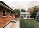Backyard showing new shed, brick home, fenced yard, and landscaped yard at 11673 W 28Th Ave, Lakewood, CO 80215