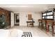Finished basement with exposed brick, bar seating, and neutral decor, creating a versatile living space at 11673 W 28Th Ave, Lakewood, CO 80215