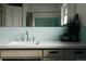 Bathroom sink with tiled backsplash, modern fixtures, and white cabinets at 11673 W 28Th Ave, Lakewood, CO 80215
