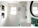 Modern bathroom featuring white subway tiles, a walk-in shower, and sleek fixtures at 11673 W 28Th Ave, Lakewood, CO 80215