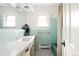 Charming bathroom with classic tilework, vintage fixtures, and plenty of natural light at 11673 W 28Th Ave, Lakewood, CO 80215