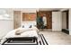 Cozy bedroom features a comfortable bed, exposed brick, and ample storage space at 11673 W 28Th Ave, Lakewood, CO 80215