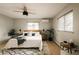 Spacious bedroom featuring a ceiling fan, two windows, and modern minimalist furniture at 11673 W 28Th Ave, Lakewood, CO 80215