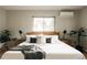 Bright bedroom with neutral decor, a large window, and modern minimalist furniture at 11673 W 28Th Ave, Lakewood, CO 80215
