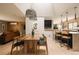 Open dining area with modern lighting, hardwood floors, and seamless transition to the kitchen and living room at 11673 W 28Th Ave, Lakewood, CO 80215