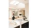 Dining area with modern lighting, skylight, tile backsplash and view into open concept living space at 11673 W 28Th Ave, Lakewood, CO 80215
