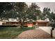 Well-maintained ranch home featuring a large tree, inviting front lawn, and a two-car garage at 11673 W 28Th Ave, Lakewood, CO 80215